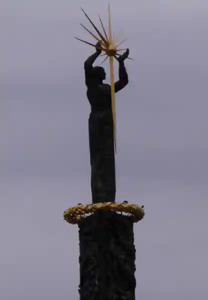 The bronze man and the sun monument, full body